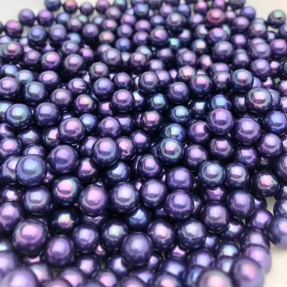 Close-up of purple pearls on a white background