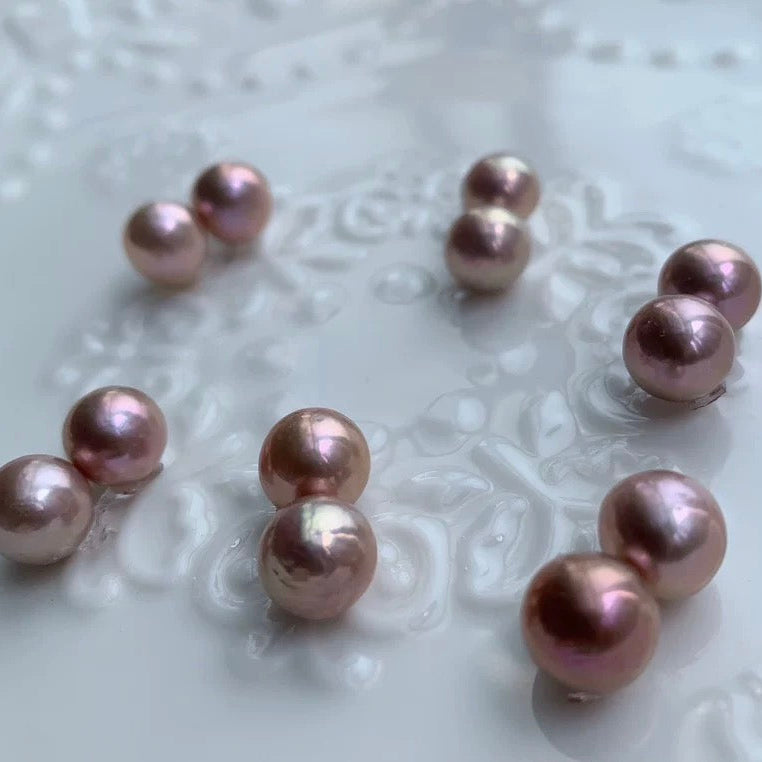Pink pearls on a textured white surface